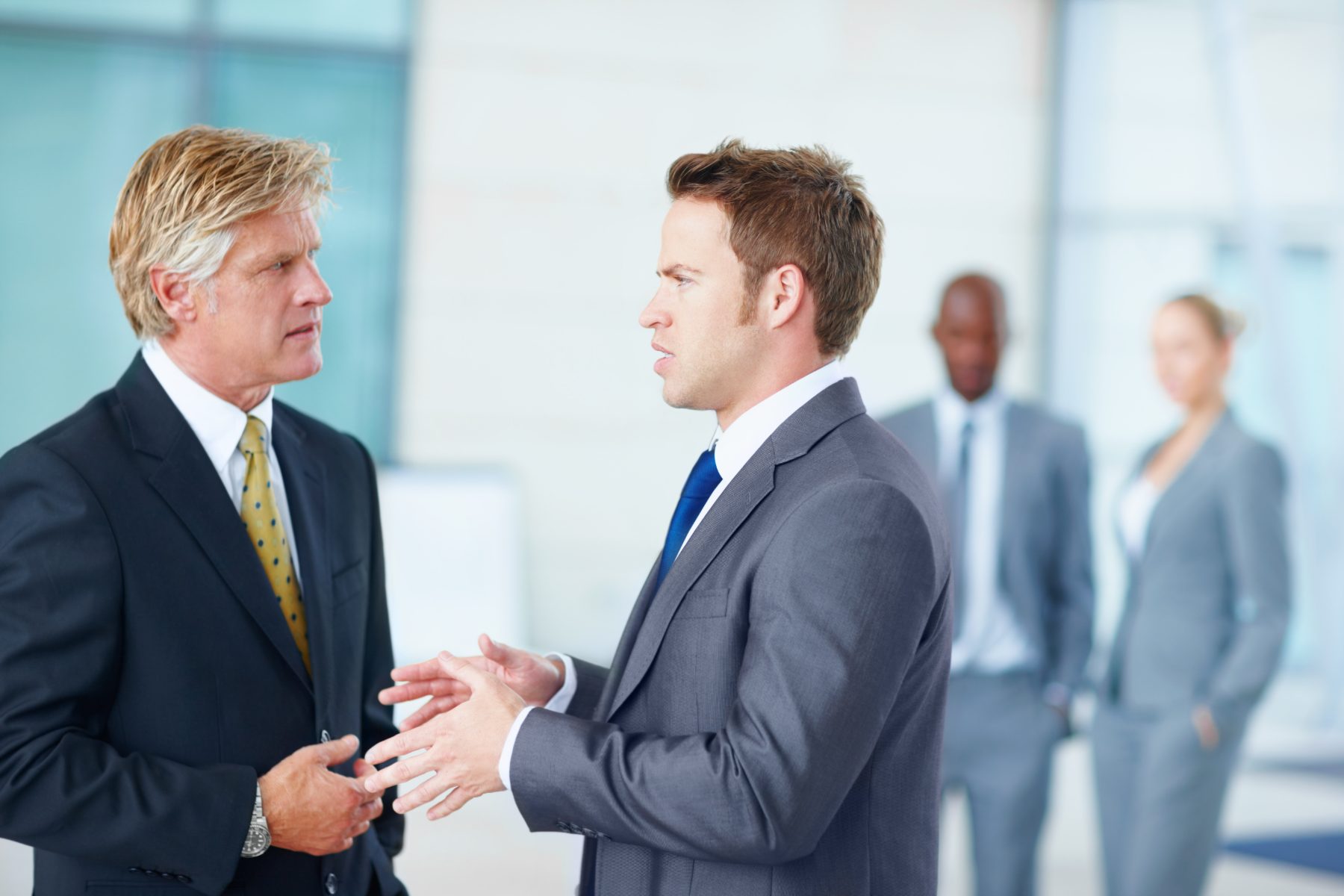 Two businessmen in conversation in a bright office